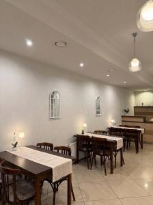 a dining room with tables and chairs and a piano at Annabella in Riga
