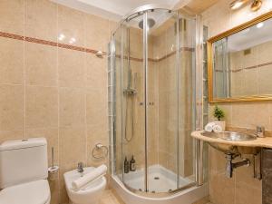 a bathroom with a shower and a toilet and a sink at Casa do Criativo ® Bed&Breakfast in Almada +22 photos