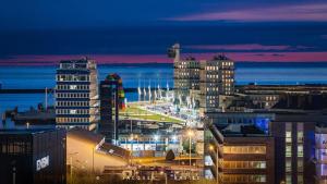 a view of a city at night with buildings at Studio cosy proche plage & centre in Le Havre