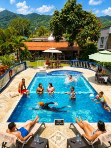 a group of people in a pool at a resort at Complejo Campestre Salome Cabañas & Hotel in Calima