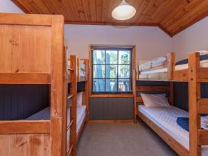 a bedroom with four bunk beds in a cabin at Wairo Beach Holiday Park in Lake Tabourie +143 photos
