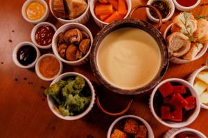 a table with many different dishes of food on it at Villa do Vale Boutique Hotel in Blumenau