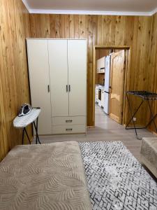 a room with a large white cabinet and a kitchen at Kausar cottage in Cholpon-Ata +8 photos