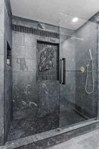 a bathroom with a shower with a glass at Kit inn Wetrock in Moab +35 photos