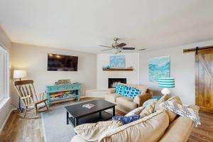 a living room with a couch and a table at Dog-Friendly Lakefront Home with Private Sundeck in Kingsland