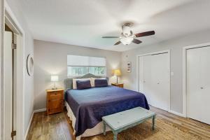 a bedroom with a bed and a ceiling fan at Dog-Friendly Lakefront Home with Private Sundeck in Kingsland
