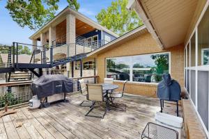 a house with a deck with a table and chairs at Dog-Friendly Lakefront Home with Private Sundeck in Kingsland