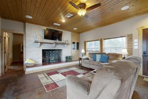a living room with two couches and a fireplace at Renovated Waterfront Home with WiFi, Lake Views, Dock & Boat Lift - Dogs OK in Buchanan Dam