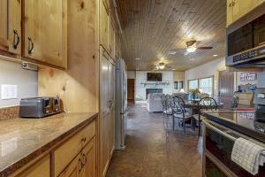 a kitchen with a counter and a dining room at Renovated Waterfront Home with WiFi, Lake Views, Dock & Boat Lift - Dogs OK in Buchanan Dam