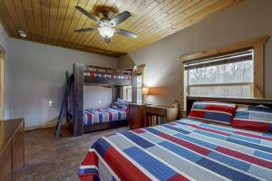 a bedroom with a bed and a bunk bed at Renovated Waterfront Home with WiFi, Lake Views, Dock & Boat Lift - Dogs OK in Buchanan Dam