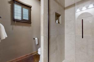 a bathroom with a shower and a toilet at Renovated Waterfront Home with WiFi, Lake Views, Dock & Boat Lift - Dogs OK in Buchanan Dam +18 photos