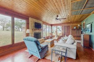 a living room with a couch and a fireplace at Historic Lakefront & Wildlife Haven with Firepit & Gas Grill - Minutes to Water in Burnet