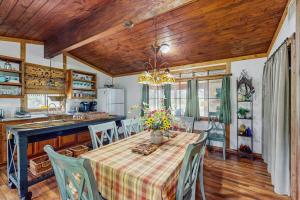 a kitchen and dining room with a table and chairs at Historic Lakefront & Wildlife Haven with Firepit & Gas Grill - Minutes to Water in Burnet