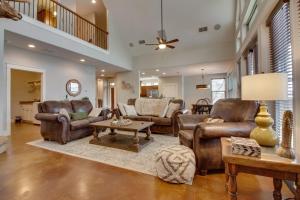 a living room with leather furniture and a table at Lakefront Home with WiFi, Entertainment, Dock & Lake Views - Dogs OK in Buchanan Dam
