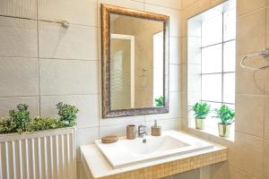 a bathroom with a sink and a mirror at IFESTOS APARTMENTS in Ierissos +29 photos