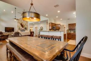 a dining room and living room with a wooden table at Lakefront Home with WiFi, Entertainment, Dock & Lake Views - Dogs OK in Buchanan Dam