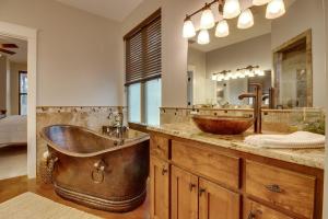 a large bathroom with a copper tub and a sink at Lakefront Home with WiFi, Entertainment, Dock & Lake Views - Dogs OK in Buchanan Dam +38 photos