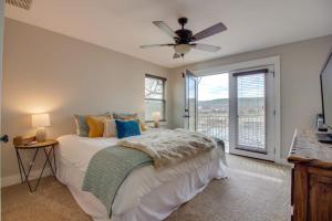 a bedroom with a bed and a ceiling fan at Lakefront Home with WiFi, Entertainment, Dock & Lake Views - Dogs OK in Buchanan Dam