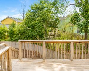 a wooden deck with a fence and trees at luxury condo, pet friendly, close to everything in Augusta