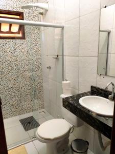 a bathroom with a shower and a toilet and a sink at Casas Bela da Chapada in Lençóis +19 photos