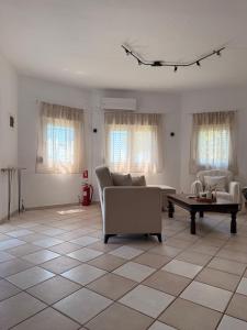 a living room with a couch and a table at The Family Villa in Tragasiá