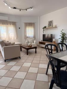 a living room with a couch and a table at The Family Villa in Tragasiá