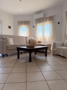 a living room with a couch and a coffee table at The Family Villa in Tragasiá
