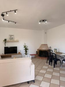 a living room with a couch and a table and a fireplace at The Family Villa in Tragasiá