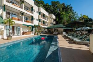 a swimming pool in front of a building at Villa do Vale Boutique Hotel in Blumenau