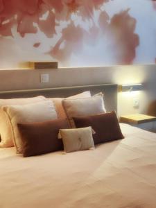 a bedroom with a large bed with pillows on it at Zaza Suites in Middelkerke