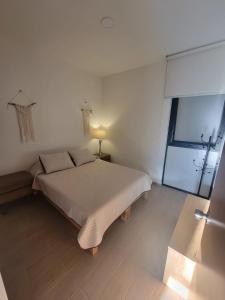 a white bedroom with a bed and a window at Condo PH Lago Luna, Chante in Chantepec +27 photos