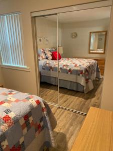 a mirror in a bedroom with a bed and a bed sqor at #13 Condo near large pool-Gorge shuttle-book separately in Quincy +20 photos