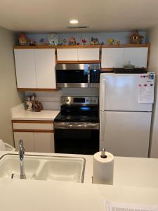 a kitchen with a refrigerator and a sink at #13 Condo near large pool-Gorge shuttle-book separately in Quincy