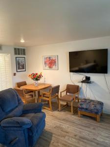 a living room with a couch and a table and a tv at #13 Condo near large pool-Gorge shuttle-book separately in Quincy