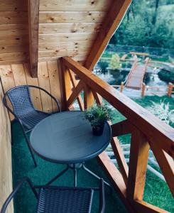 a table and two chairs on a porch at Domki Zielony Raj Rabka- Zdrój Jacuzii na wyłączność Sauna in Rabka-Zdrój