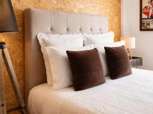 a bedroom with a white bed with pillows at Casa do Criativo ® Bed&Breakfast in Almada
