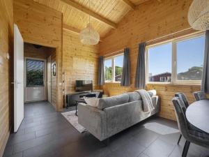 a living room with a couch and a table at Country Holiday home with shared pool in Someren-Heide