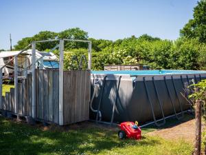 a small red toy car parked next to a pool at Country Holiday home with shared pool in Someren-Heide