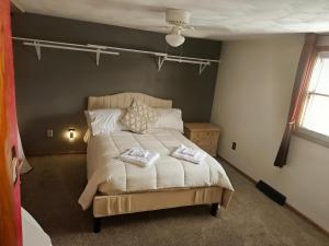 a bedroom with a bed with two pillows on it at Del La Rose in Clarksburg