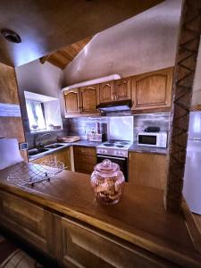 a kitchen with wooden cabinets and a counter top at Leos Traditional Holiday House in Leonidio +11 photos