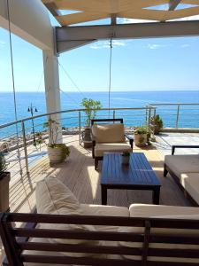 a balcony with couches and a view of the ocean at Gonis Suites in Palaiochora