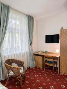 a hotel room with a desk and a window at Annabella in Riga