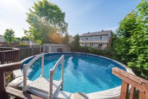 a large swimming pool with a chair at Pool, BBQ & Foosball Spacious 4BR Home in Gatineau