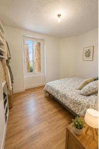a bedroom with a bed and a window at Maison de vacances in Capdenac-Gare