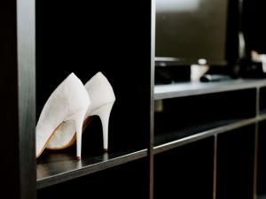 a pair of white heels sitting on a shelf at Ibis Sofia Airport Hotel in Sofia +117 photos