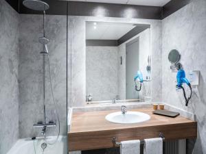 a bathroom with a sink and a shower and a mirror at Ibis Styles A Coruna in A Coruña