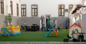 a playground with play equipment on a lawn at Residencial Moderna in Figueira da Foz +14 photos