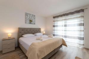 a bedroom with a large bed and a window at Villa Zrilic with Private Pool in Benkovac +39 photos