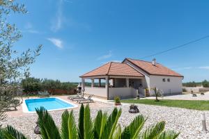 a villa with a swimming pool and a house at Villa Zrilic with Private Pool in Benkovac