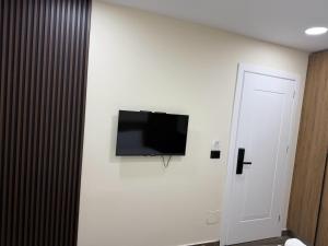 a flat screen tv on a white wall in a room at EDEAN Apartments 4 in Tirana